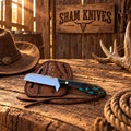 Polished 440C steel cowboy knife displayed with leather sheath