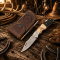 Cowboy belt carry Damascus folding pocket knife with antler and black resin handle with leather sheath.