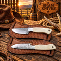 Two examples of cowboy rasp steel knives with cream-colored bone handles
