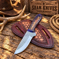 Cowboy skinning knife displayed with pancake leather belt sheath