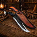 Custom hunting knife with D2 steel blade and leather sheath on rustic cowboy table