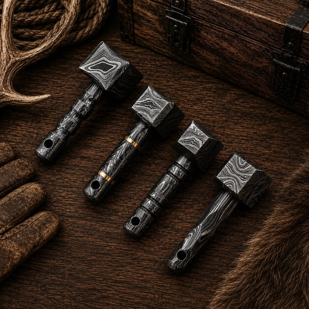 Four miniature Damascus Viking hammer design variations