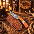 Floral-etched D2 cowboy skinner knife with orange resin handle