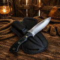 Hand forged hunting knife with black handle and leather sheath