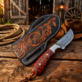 Rancher belt knife with 3.75 inch Damascus steel blade and pinecone handle with floral leather sheath on rustic wooden table with cowboy rope and hat