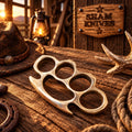 Solid hand-cast brass knuckle with four rounded finger openings
