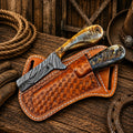 Cowboy skinning knife collection featuring Damascus steel and Western leather sheaths.