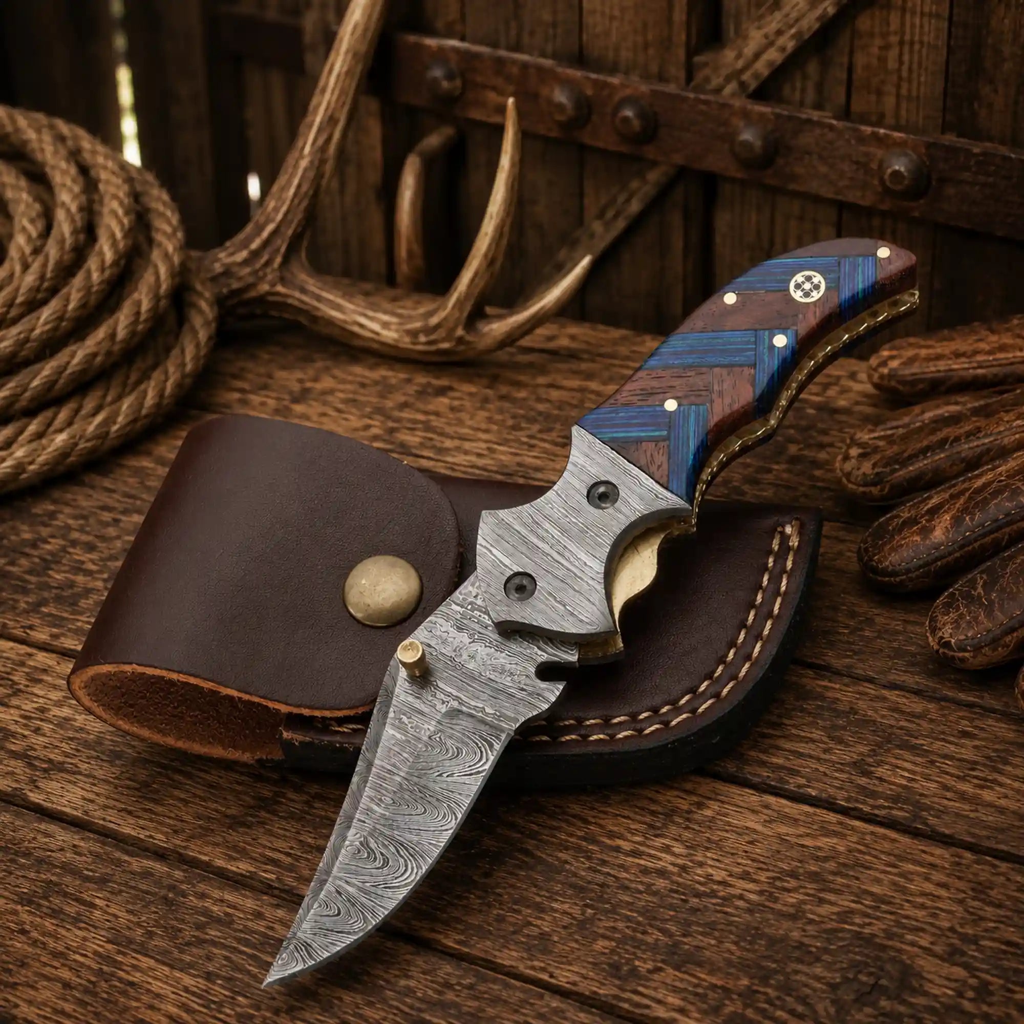 Handmade 7.25-inch Western cowboy folding pocket knife with a 3.10-inch Damascus steel blade, compact wood handle, Damascus steel bolsters, and premium leather sheath.