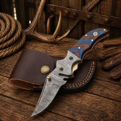 Handmade 7.25-inch Western cowboy folding pocket knife with a 3.10-inch Damascus steel blade, compact wood handle, Damascus steel bolsters, and premium leather sheath.