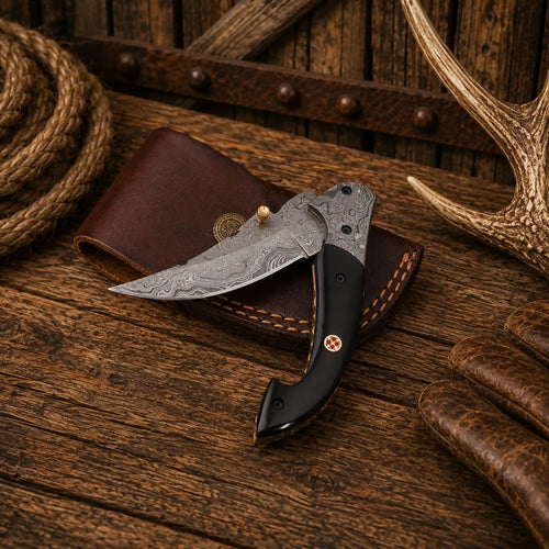 Handmade 7.25-inch Western folding pocket knife with a 3.10-inch Raindrop Damascus blade, buffalo horn handle, Damascus steel bolsters, and premium leather sheath.