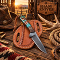 Western D2 skinning belt knife with wood and resin handle on a leather sheath
